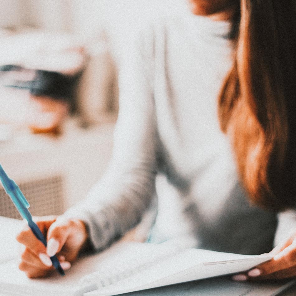 Woman writing on notepad